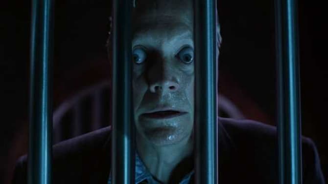 A man's face stretching as he sticks it between metal bars, from X-Men (2000).